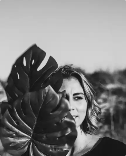 Amy Maxwell behind a plant
